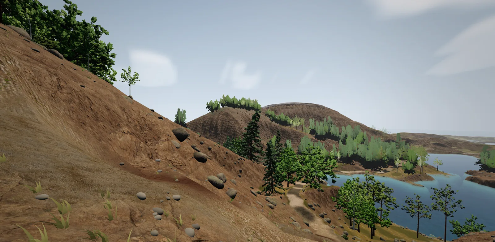 A gravel road running as a level shelf across an open hillside above a lake.